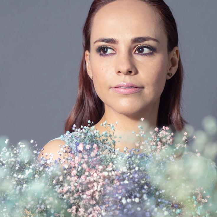 Avery Chen, Lead Design Curator at Silver Forest Portal, reviewing corporate floral arrangements